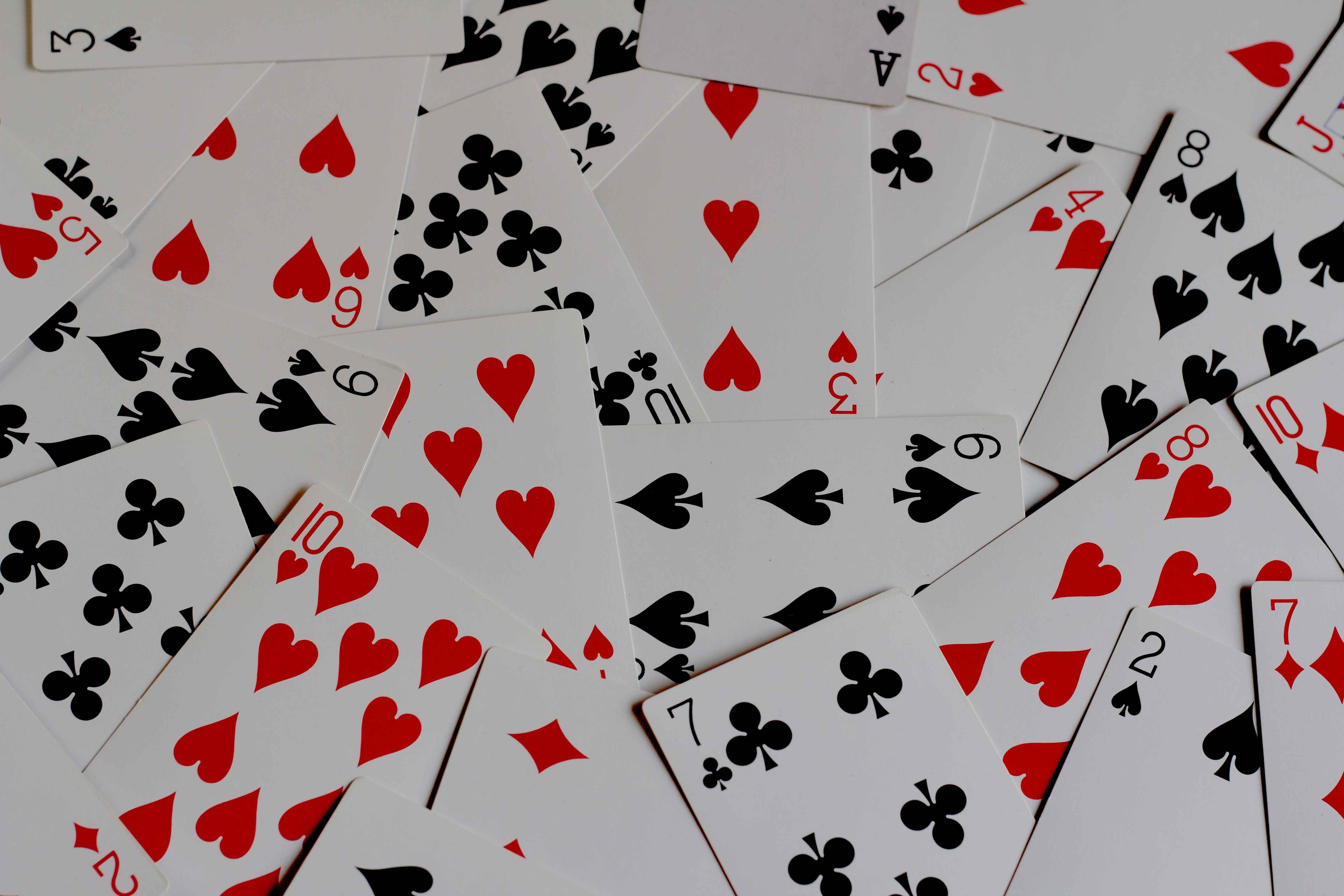 a pile of playing cards with hearts and spades; Credit: @aceofnet on Unsplash